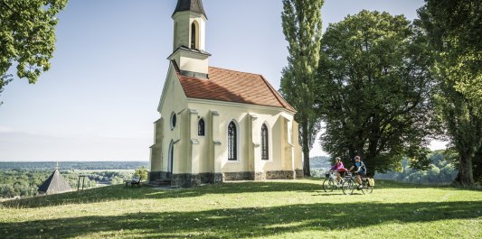 Die Kapelle St. Georg wurde als Gelöbniskapelle errichtet, nachdem ein mit 1000 Scheffel Getreide beladener Schiffzug an der Brücke in Braunau zu zerschellen drohte. Die Kapelle steht auf dem Schlossberg in Kraiburg a. Inn., © Inn-Salzach Tourismus